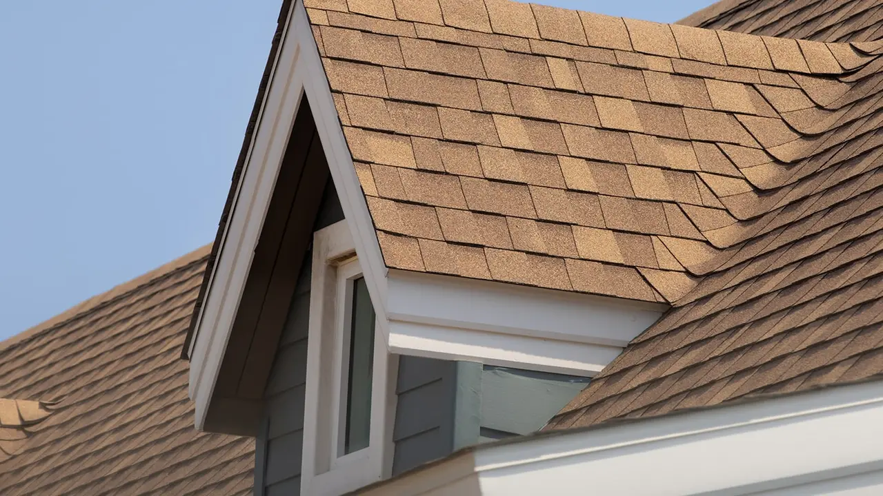 A Radiant roofing crew mid roof replacement on a Sioux Falls two-story, one slope stripped back to the deck.