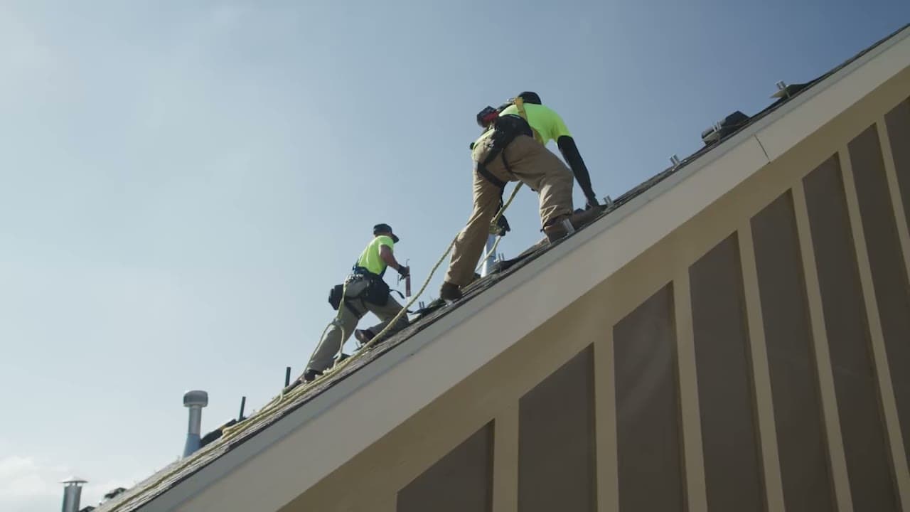 Radiant roofing contractors working on a shingle roof in Sioux Falls, South Dakota.